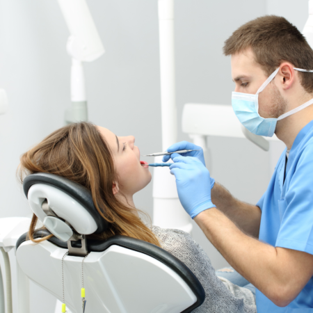 dentist with patient in chair